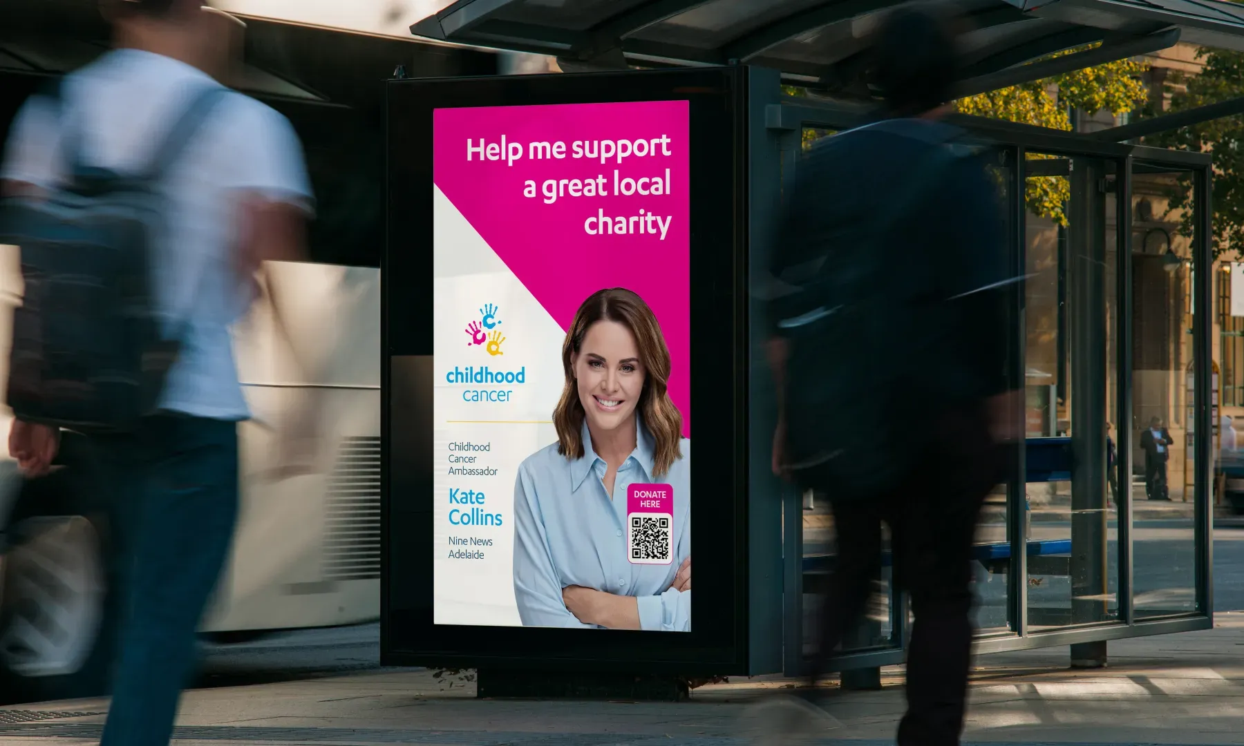 Childhood Cancer Association fundraising advertisement featuring ambassador Kate Collins at a bus shelter